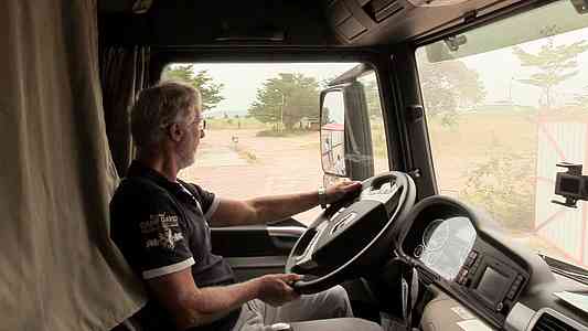 Wini reverses one of the trucks to park it.