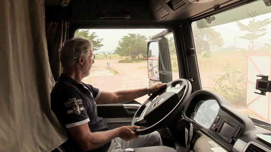 Wini reverses one of the trucks to park it.