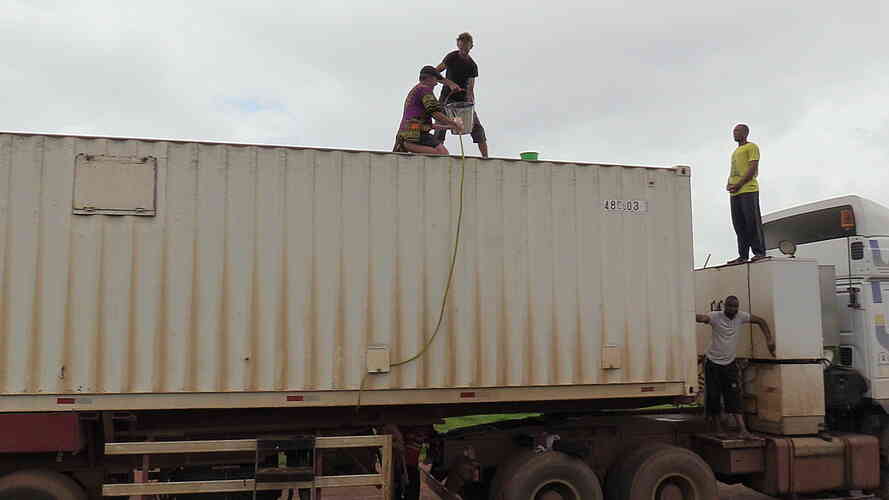 Filling the truck’s water tanks up, one bucket at a time