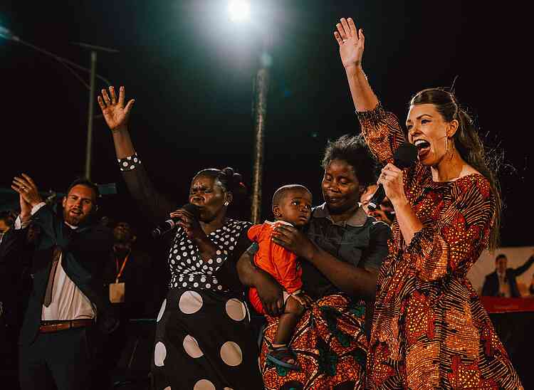 This young mother, Sarah, brought her son Darius to the stage. She was so excited, she could barely get the words out to tell us that her baby’s neck had been bent and stiff since birth.